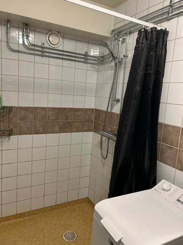 a shower with a black shower curtain in a bathroom at CITY Centrum in Gothenburg