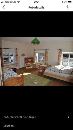 a bedroom with two beds and a table and chairs at Ferienhaus Wietsche in Burscheid