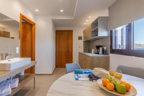 a kitchen with a table with a plate of fruit on it at Anna Studio in Amoudara Herakliou