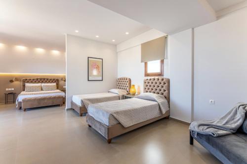 a bedroom with two beds and a couch at Anna Studio in Amoudara Herakliou
