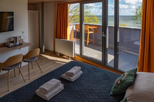 a bedroom with a bed and a view of the ocean at Tawerna Rybaki in Sopot