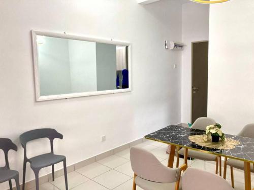 a dining room with a table and chairs and a mirror at AYMAR Homestay, Youth City. in Nilai