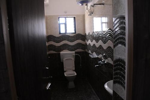 a bathroom with a toilet and a sink at Rivasa homes in Deoghar