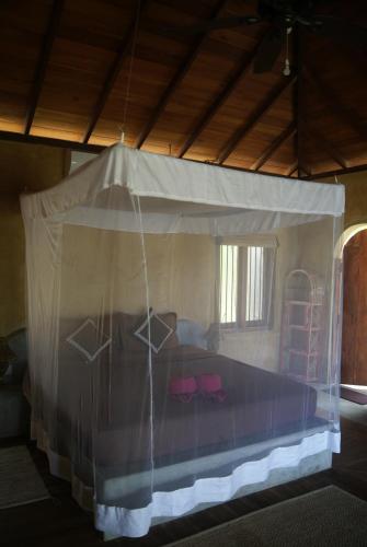 a bed with a canopy in a room at Kitelantis Hotel and Resort in Kalpitiya