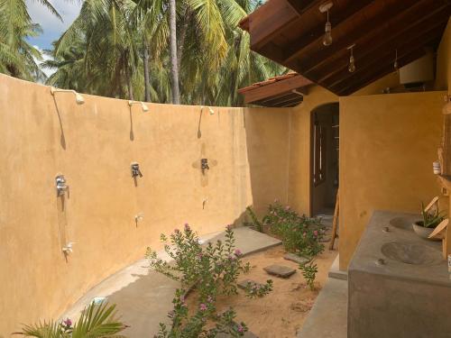 a building with a wall with two showers at Kitelantis Hotel and Resort in Kalpitiya