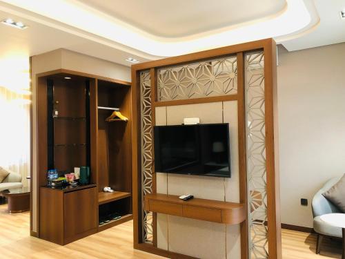 a living room with a flat screen tv in a room at Hanvet Hotel Do Son in Ðố Sơn