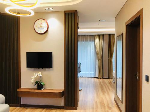 a hotel room with a television and a living room at Hanvet Hotel Do Son in Ðố Sơn