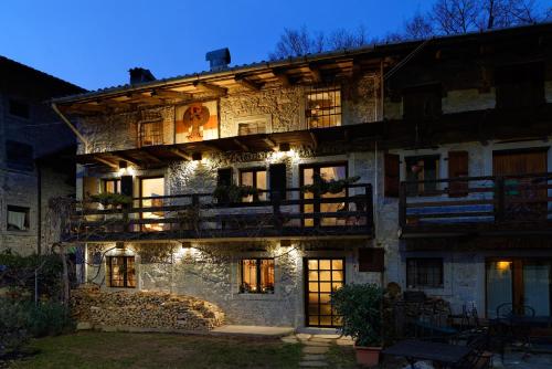 an old stone building with lights on it at night at TORRE DEL GRIFONE nel medioevo di Cividale del Friuli in Faedis