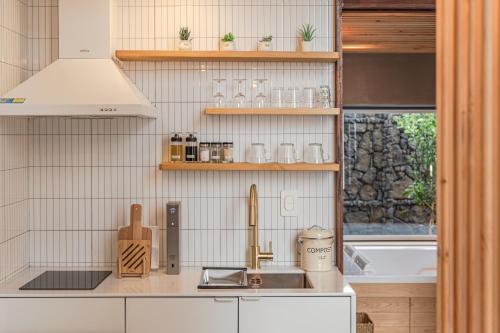 a kitchen with a sink and a counter top at Le Village Aewol G in Jeju