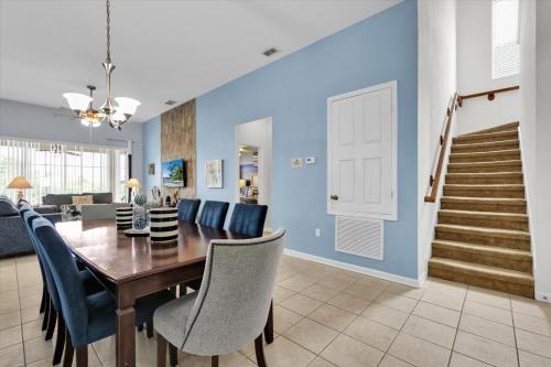 a dining room and living room with a table and chairs at Retro Noir in Orlando