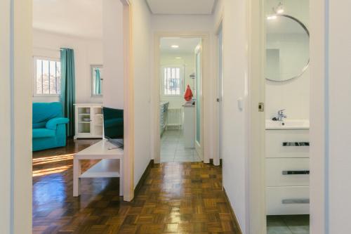 a hallway with a bathroom with a sink and a mirror at Madrid Rio in Madrid