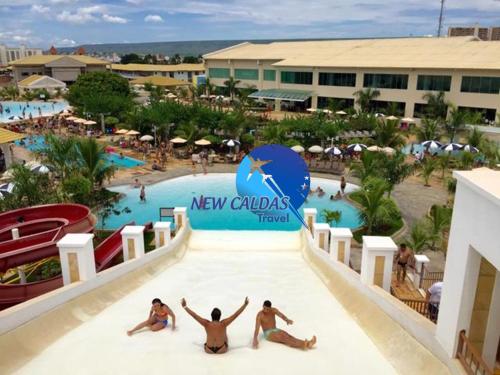 a group of people sitting on a slide at a resort at Lacqua Diroma Flat - Oficial in Caldas Novas