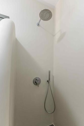 a shower with a shower head in a bathroom at Ktima Drilli - Experience the authentic Naxian lifestyle in Áno Potamiá