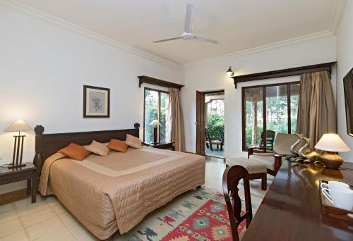 a bedroom with a bed and a table and chairs at Manvār Shergarh , The Desert Resort in Dechu