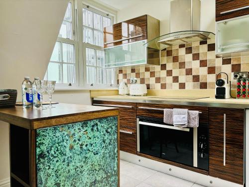 a kitchen with a large aquarium in the middle at ROBERT HOUSE in London