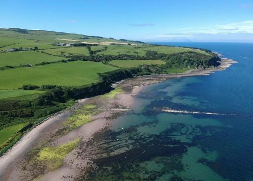 an aerial view of a beach and the ocean at Heads Of Ayr Holiday Park in Ayr