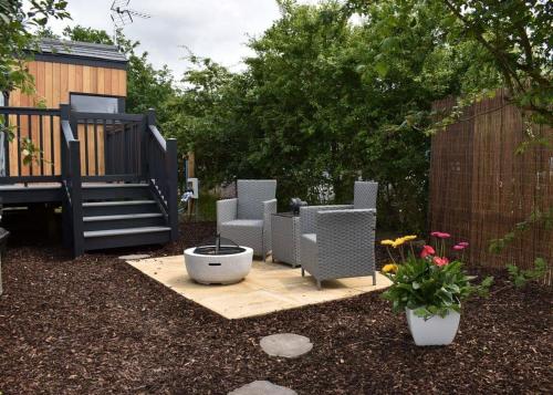 a garden with chairs and a table and a fence at Watermill Leisure Park 