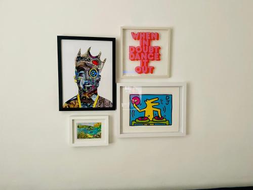 four framed pictures on a white wall at 4 Market Street in Bantry