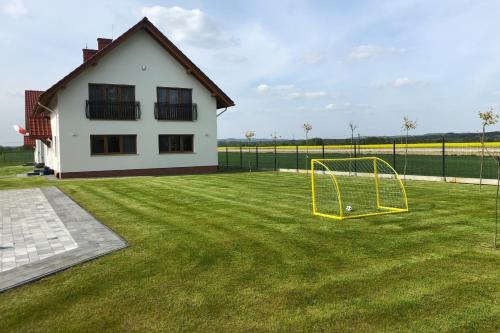 a yard with a soccer goal in front of a house at Dobranocka Noclegi - blisko Energylandia in Spytkowice