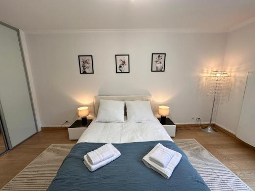 a bedroom with a large bed with two pillows on it at Cosy apartment at Gates of Paris in Vincennes