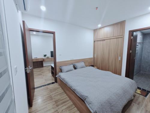 a bedroom with a bed and a mirror at Homestay 801 in Lạng Sơn