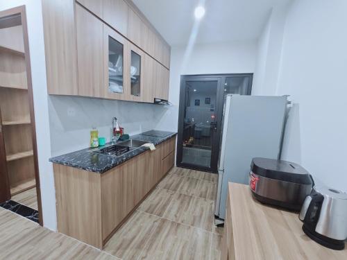 a kitchen with a refrigerator and a counter top at Homestay 801 in Lạng Sơn
