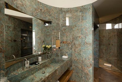 a bathroom with a large sink and a mirror at Palazzo Shedir - The Leading Hotels of the World in Rome