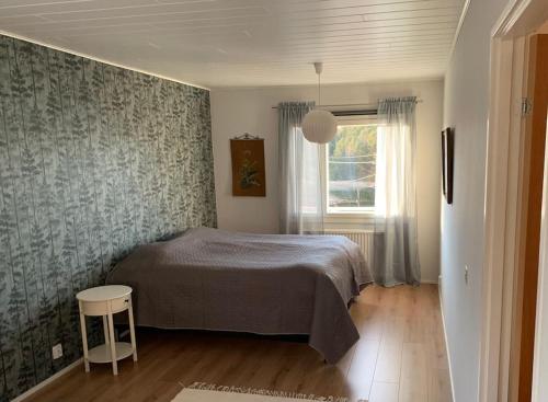 a bedroom with a bed and a window at Kalles, skärgårdsidyll med utsikt över Hamnsundet in Saltvik