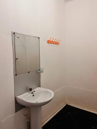 a bathroom with a sink and a mirror on the wall at Wave Hunters in Arugam Bay