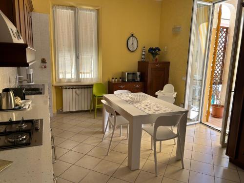 a kitchen with a white table and chairs in a room at Casa Erika al mare in Varazze