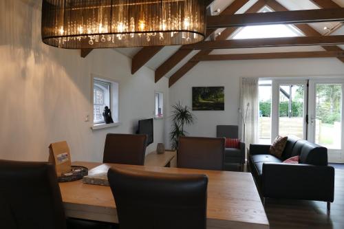 a living room with a table and chairs and a dining room at Vakantiewoning 't Stookhok Gasselte in Gasselte