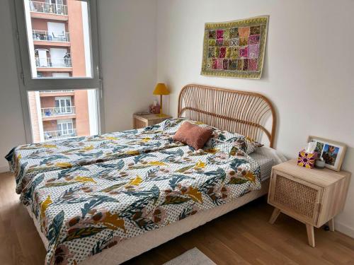 - une chambre avec un lit doté d'une couette et d'une fenêtre dans l'établissement Barba Artful Flat, cosy flat 10 minutes from Paris, à Romainville