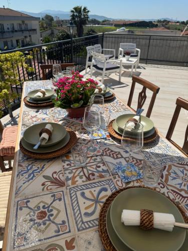 a table with plates of food on a patio at Come a Casa in Paestum