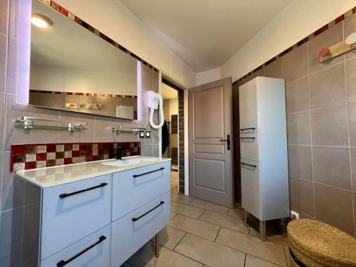 a kitchen with white cabinets and a refrigerator at Appartement ALERIA 2/4 personnes in Aléria