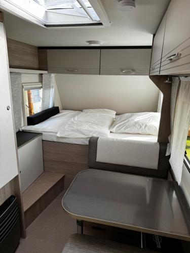 a small room with a bed and a table in it at Reisemobil Zentrum Berlin in Berlin