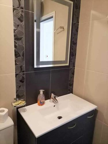 a bathroom with a sink and a mirror at Vila Antorini-Anikoapartman 2 in Sveti Vlas