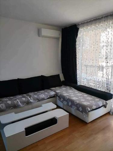 a living room with a couch and a window at Vila Antorini-Anikoapartman 2 in Sveti Vlas