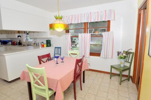a kitchen and dining room with a pink table and chairs at Castle View - Wifi, Pet Friendly, Screen Porch, Game Room, Grill, Family Friendly, Kid Friendly, Fireplace in Berkeley Springs