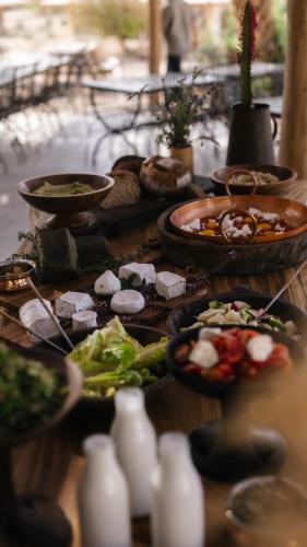 a table with many plates of food on it at Moa Living in Ẕofar