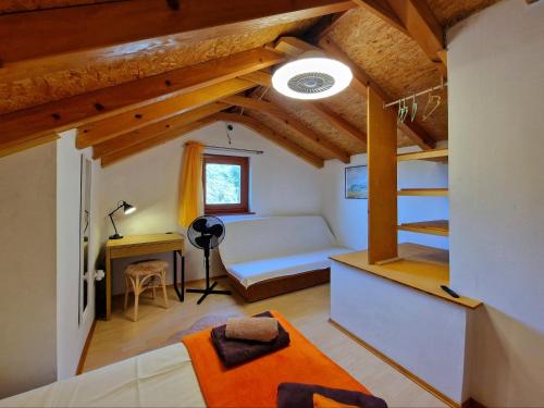 a bedroom with a bed and a desk in a room at Holiday home Maslinova in Vela Luka