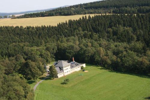 an aerial view of a large house in a field at Ferienwohnung für 4 Personen ca 55 qm in Sayda, Sachsen Osterzgebirge in Sayda