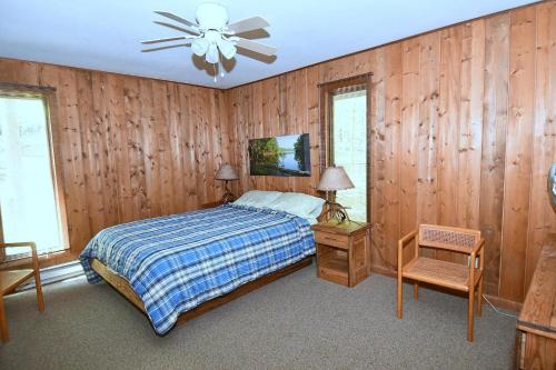 a bedroom with a bed and a ceiling fan at Haven Home - Deck, Grill, Hiking, Pool Access, Games, Community Playground and Tennis Courts in Berkeley Springs