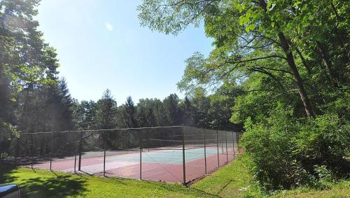 a tennis court in the middle of a field at Haven Home - Deck, Grill, Hiking, Pool Access, Games, Community Playground and Tennis Courts in Berkeley Springs