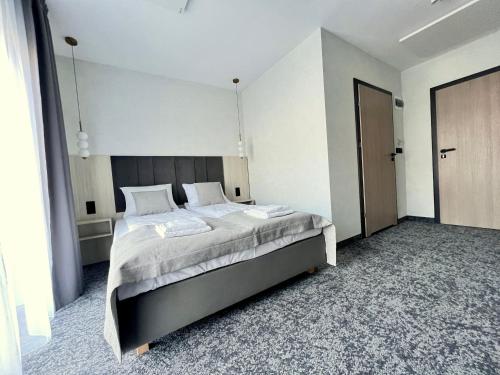 a bedroom with a large bed in a room at SILVER BALTIC in Kołobrzeg