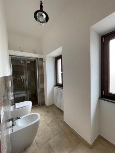 a bathroom with two toilets and a sink and a window at Greenlove in Agerola