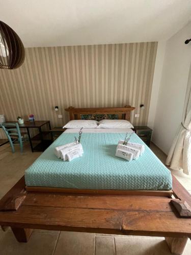 a bedroom with a bed with two bags on it at Greenlove in Agerola