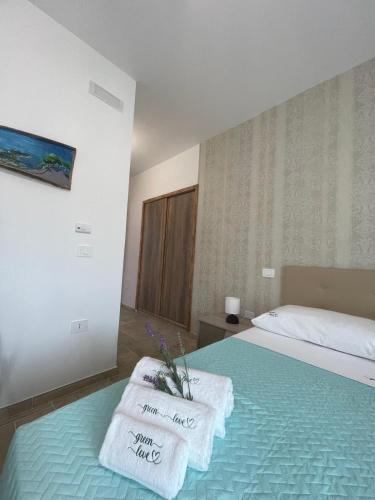 a bedroom with a bed with towels on it at Greenlove in Agerola