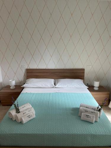 a bedroom with a bed with two towels on it at Greenlove in Agerola