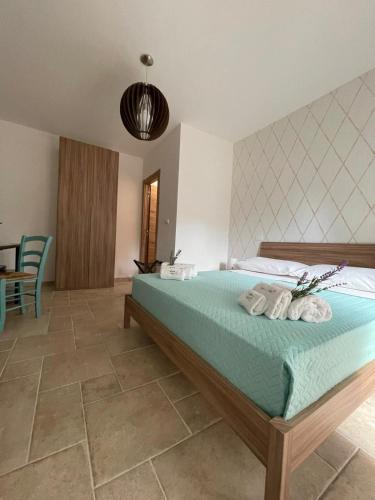a bedroom with a bed with towels on it at Greenlove in Agerola