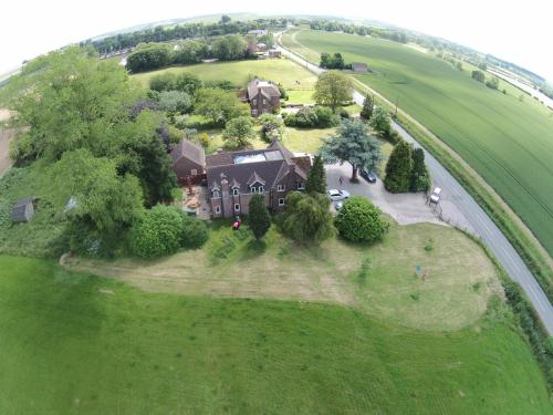 an overhead view of a large house on a green field at B&B Dorwyn Manor in Avebury